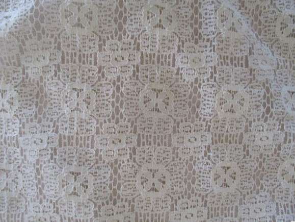 A vintage rectangular lace cloth with pretty tassel border