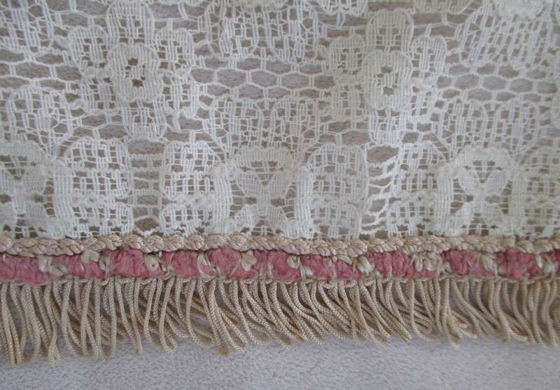 A vintage rectangular lace cloth with pretty tassel border