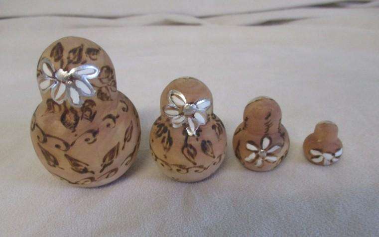 Four piece set of vintage Russian wooden hand painted Matryoshka nesting dolls