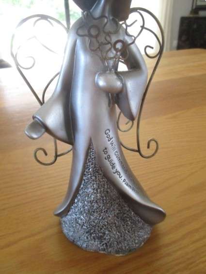 A silver tone metal angel