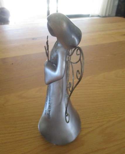 A silver tone metal angel