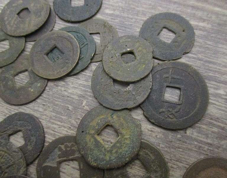An old tin full of old Chinese, South African R1, 5c and 1/2 c coins and other countries' coins