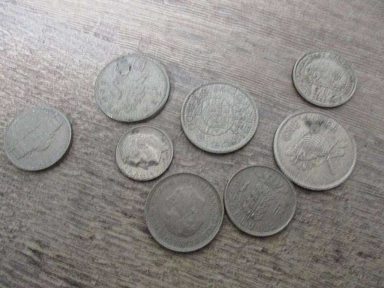 An old tin full of old Chinese, South African R1, 5c and 1/2 c coins and other countries' coins