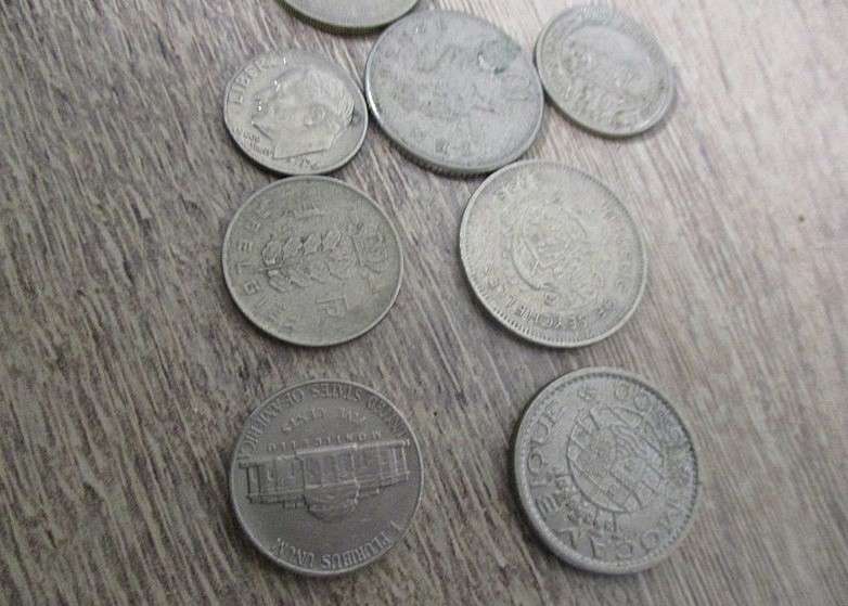 An old tin full of old Chinese, South African R1, 5c and 1/2 c coins and other countries' coins