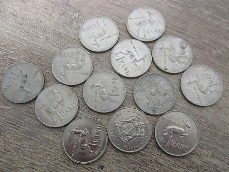 An old tin full of old Chinese, South African R1, 5c and 1/2 c coins and other countries' coins