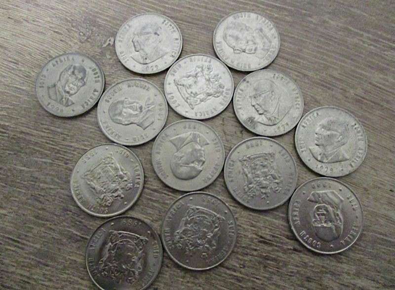 An old tin full of old Chinese, South African R1, 5c and 1/2 c coins and other countries' coins