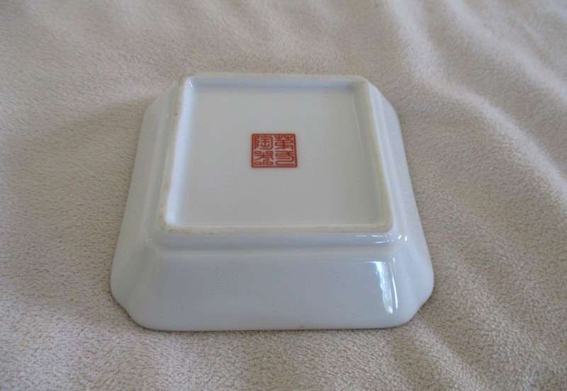 A Chinese porcelain pin dish with bird and floral design - signed