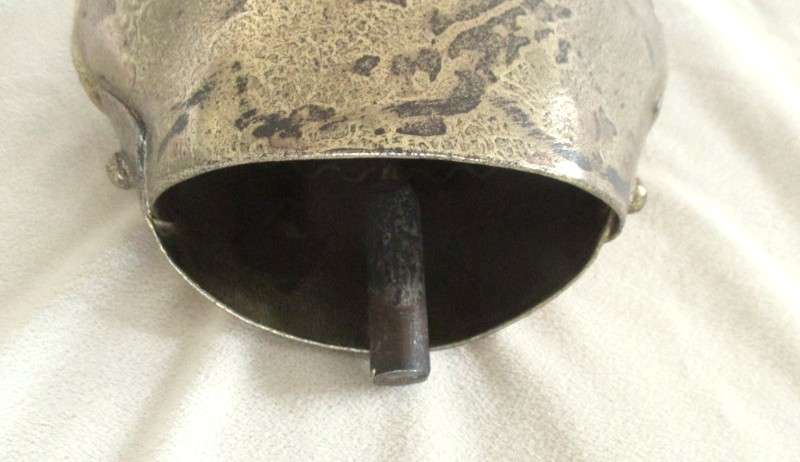 A very large vintage Swiss cow bell with ornate strap and buckle