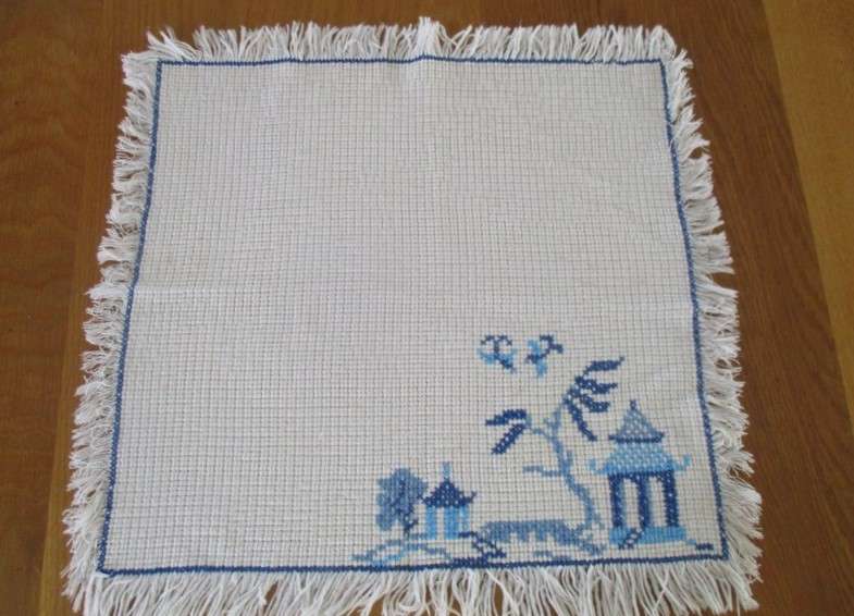 A vintage cloth hand embroidered with pretty blue cross stitch - oriental pagoda scene