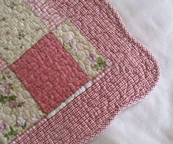A good quality MangChiNie quilted cloth - reversable with small pink roses on back
