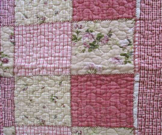 A good quality MangChiNie quilted cloth - reversable with small pink roses on back