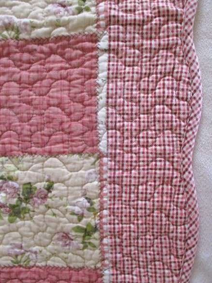 A good quality MangChiNie quilted cloth - reversable with small pink roses on back