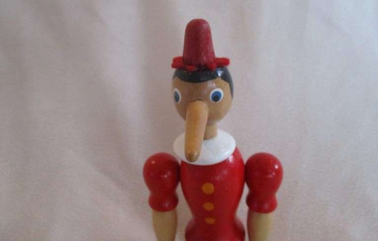 Two cute vintage wooden Pinocchios