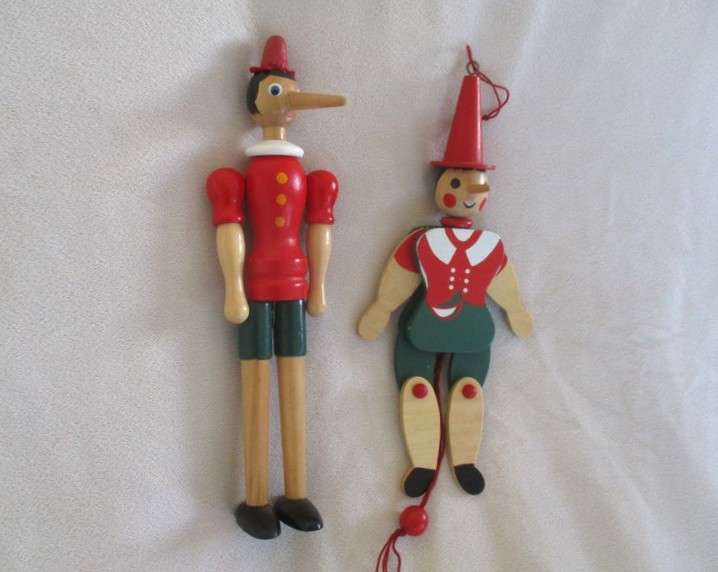 Two cute vintage wooden Pinocchios