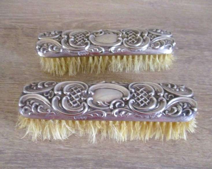 Two antique Victorian Art Nouveau repousse silver plated clothes brushes