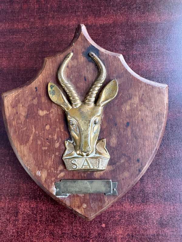 SAI brass & wood plaque