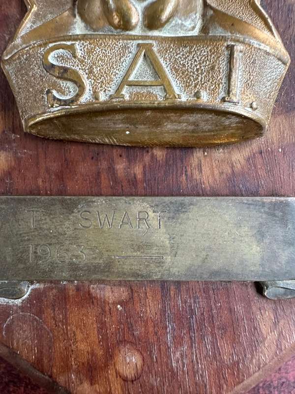 SAI brass & wood plaque