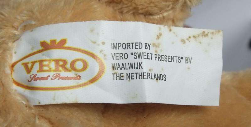 A hardened plastic dog kennel and plush dog ornament or toy made in the Netherlands for Vero sweets