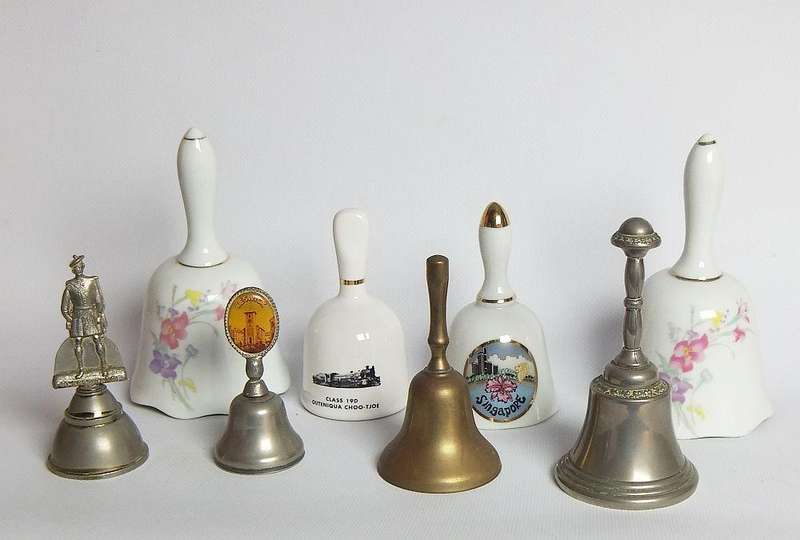 Four vintage porcelain and four vintage metal bells