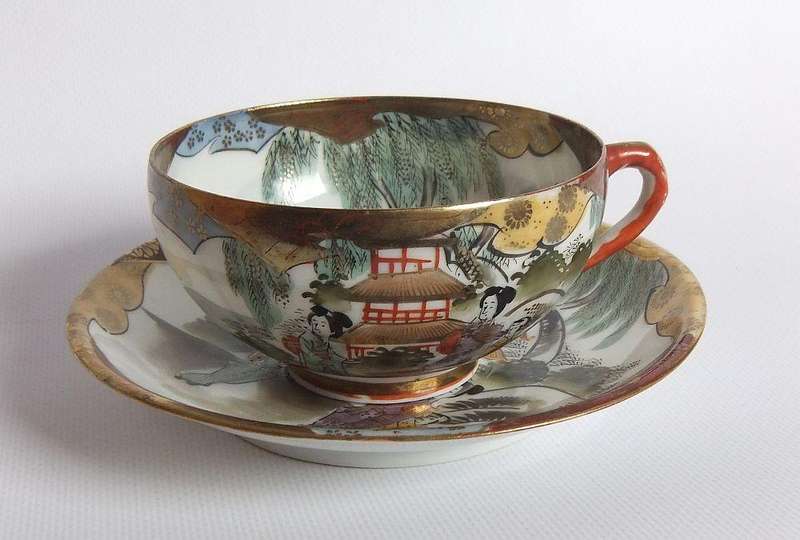 An old signed hand painted Japanese cup and saucer duo