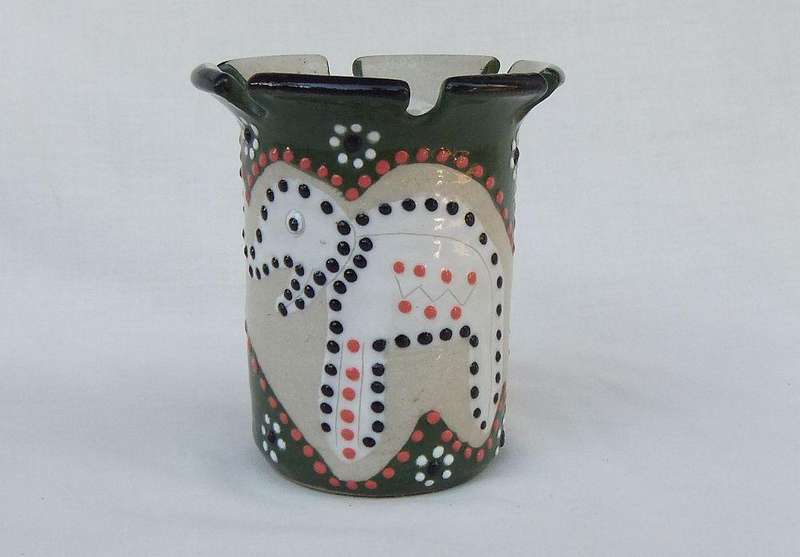 A hand made and hand painted pen holder with elephant motif dated 2001