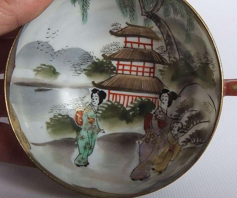 An old signed hand painted Japanese cup and saucer duo
