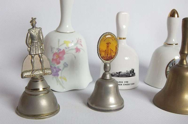 Four vintage porcelain and four vintage metal bells