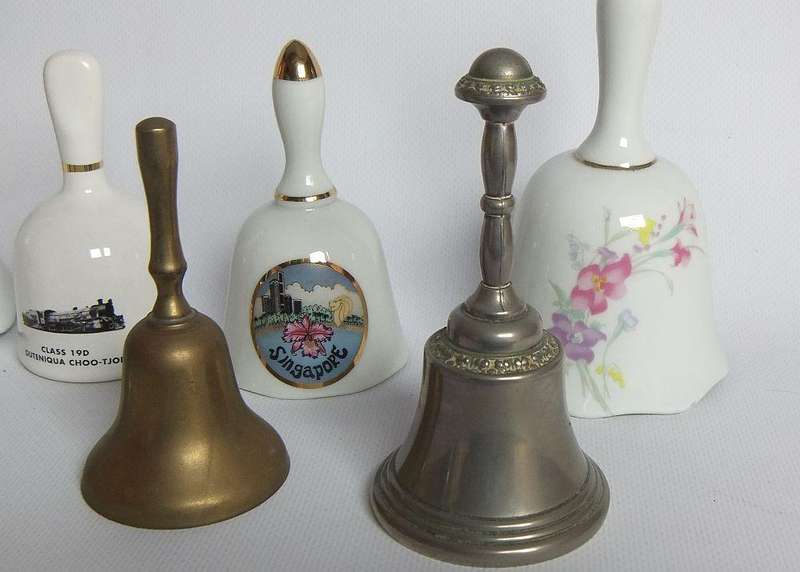 Four vintage porcelain and four vintage metal bells