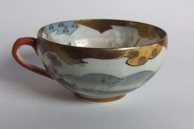 An old signed hand painted Japanese cup and saucer duo