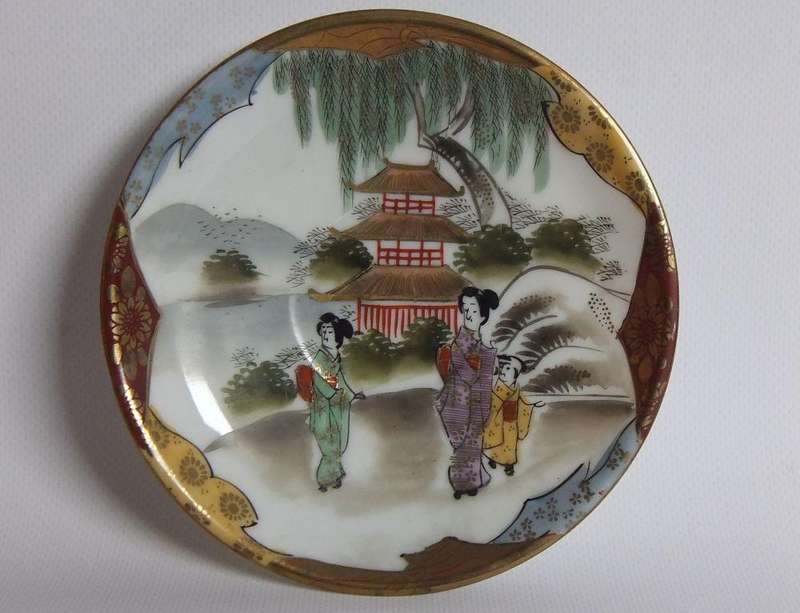 An old signed hand painted Japanese cup and saucer duo