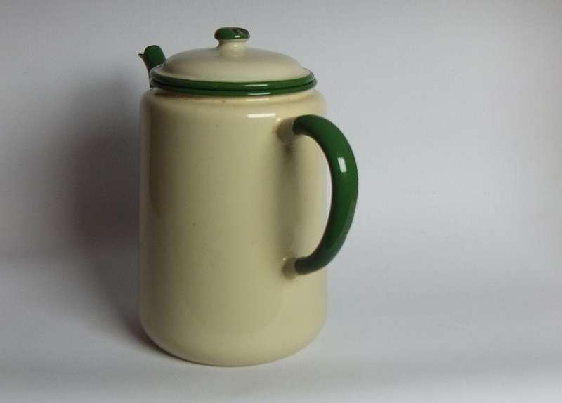 A vintage enamel camping tea or coffee pot