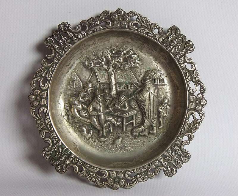 A vintage Dutch silverplate ashtray with a traditional Dutch scene
