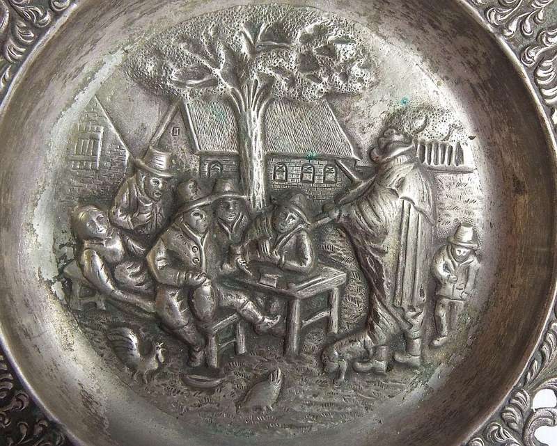 A vintage Dutch silverplate ashtray with a traditional Dutch scene