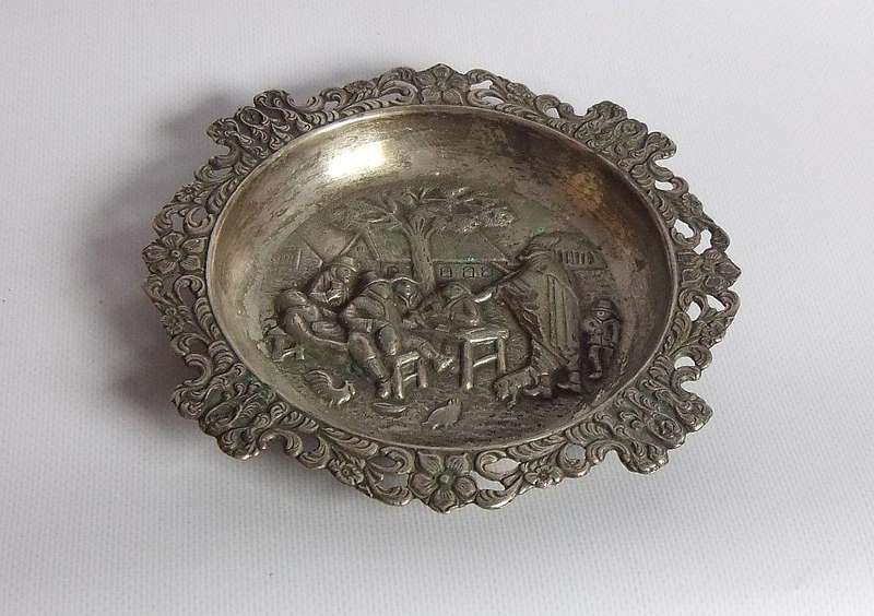A vintage Dutch silverplate ashtray with a traditional Dutch scene