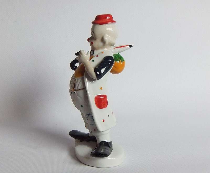 A vintage porcelain cigar smoking clown ornament