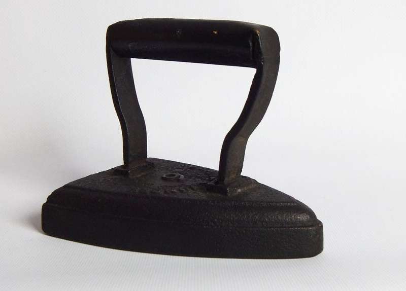 An antique coal stove iron or doorstop