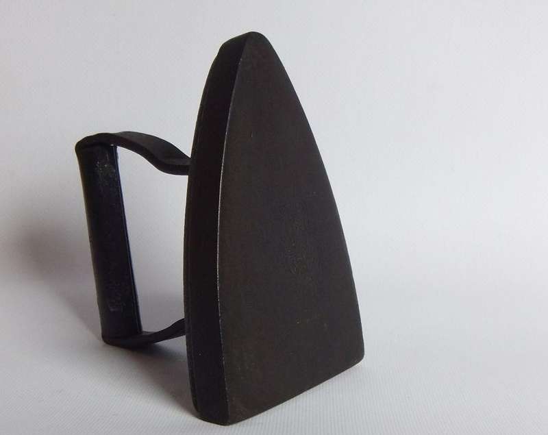 An antique coal stove iron or doorstop