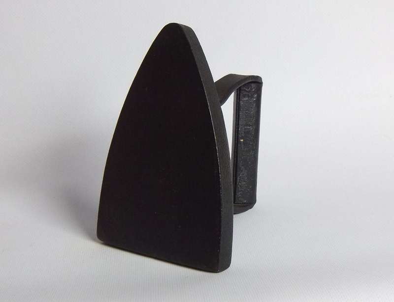 An antique coal stove iron or doorstop