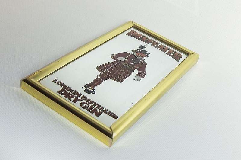 A small vintage Beefeater London Distilled Dry Gin advertising mirror