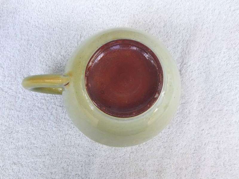 A vintage pottery ewer in the style of Globe or Linn ware pottery