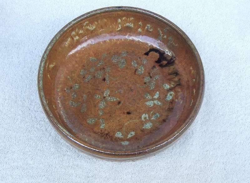 A vintage hand made pottery fruit bowl stamped on the base with an important looking makers mark