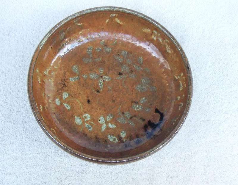 A vintage hand made pottery fruit bowl stamped on the base with an important looking makers mark