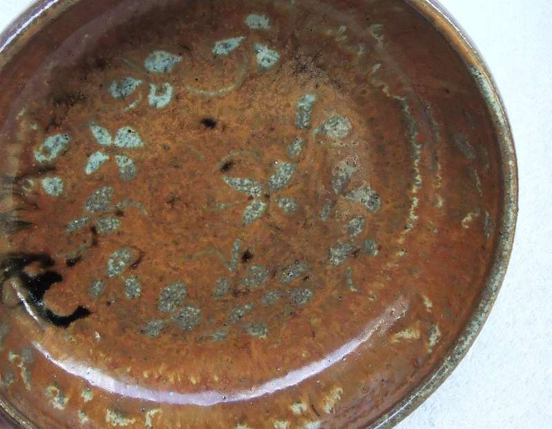 A vintage hand made pottery fruit bowl stamped on the base with an important looking makers mark