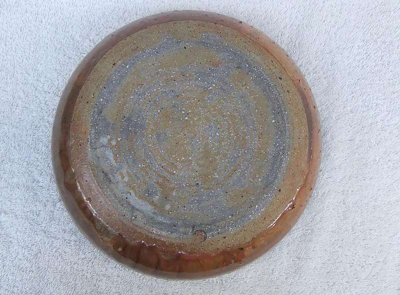 A vintage hand made pottery fruit bowl stamped on the base with an important looking makers mark