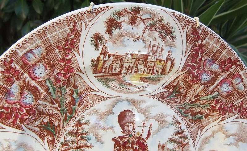 A vintage porcelain display plate by Weatherby depicting scenes of Scotland