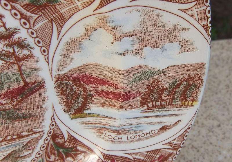 A vintage porcelain display plate by Weatherby depicting scenes of Scotland