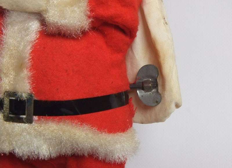 A vintage tinplate and material wind up Santa figure