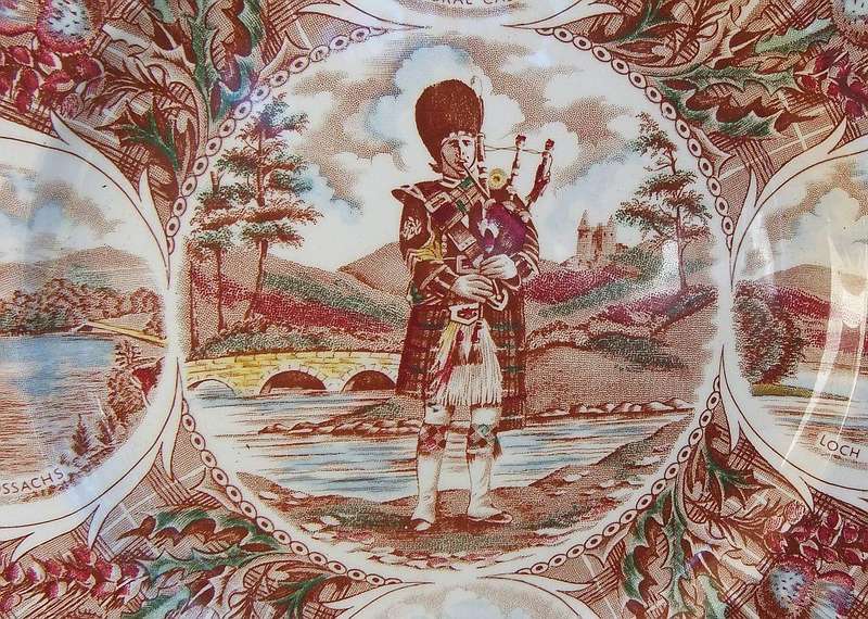 A vintage porcelain display plate by Weatherby depicting scenes of Scotland