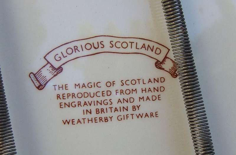 A vintage porcelain display plate by Weatherby depicting scenes of Scotland