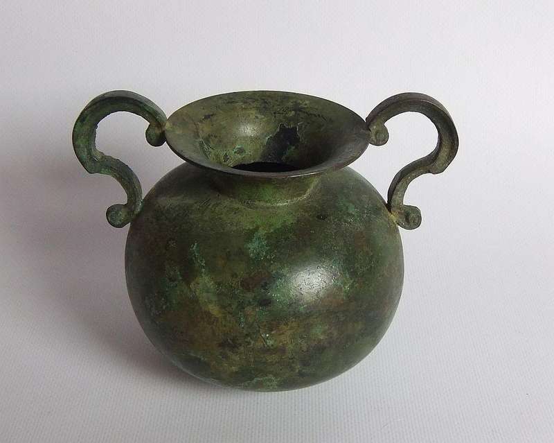 An old looking bronze patina metal flower pot